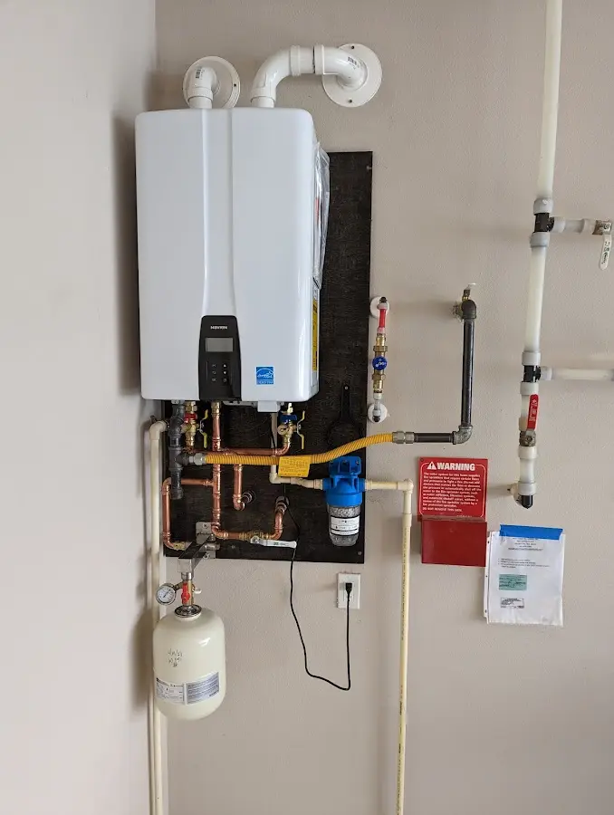 Professional plumber installing copper piping in a Chisago City home